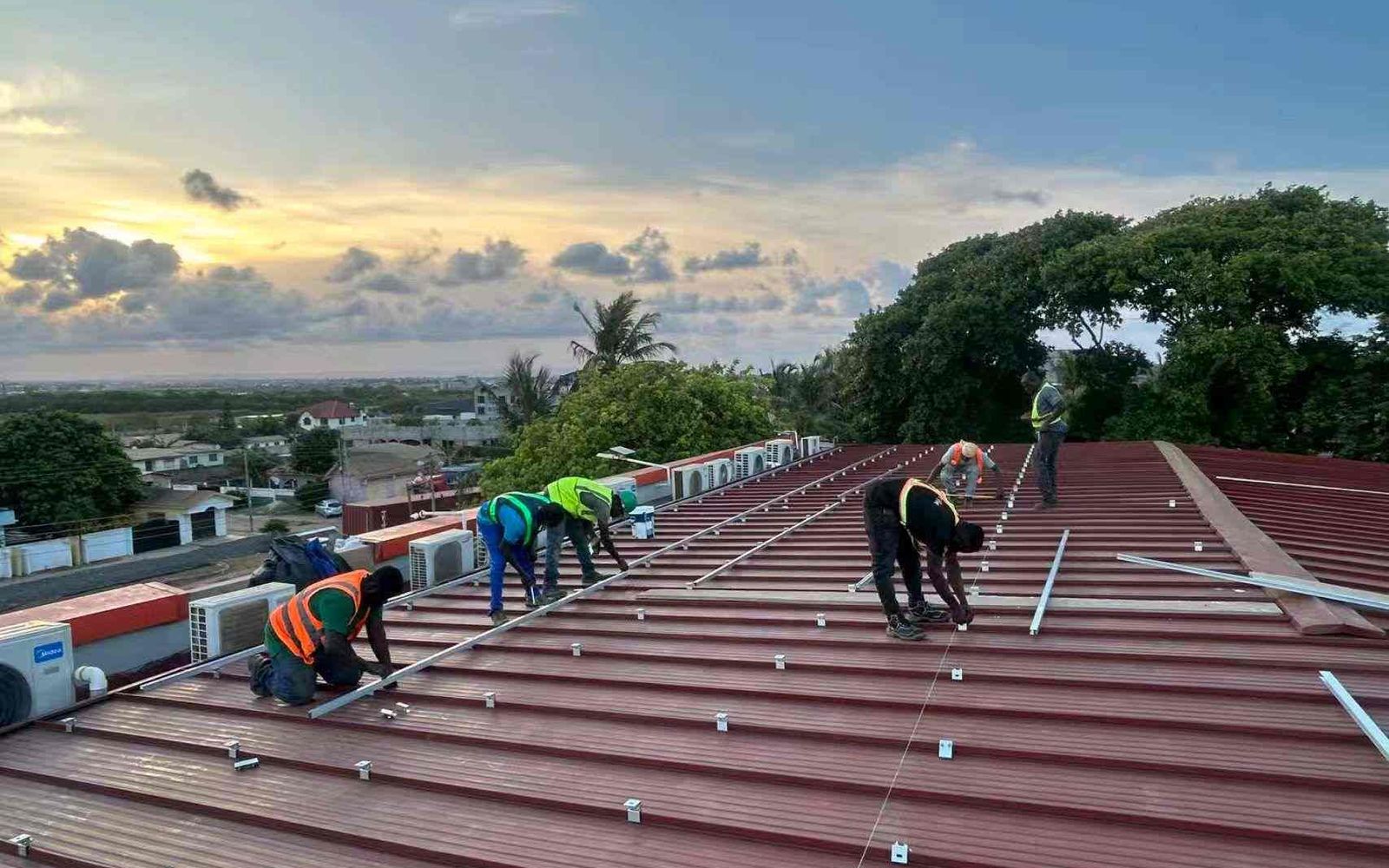 Mars Solar engineers installing mounting rails for a 250kW hotel solar system in Ghana