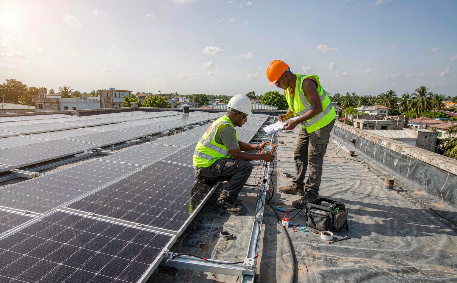 Technicians commissioning rooftop solar panels in Ghana, installation labour forms part of the solar panel price in Ghana