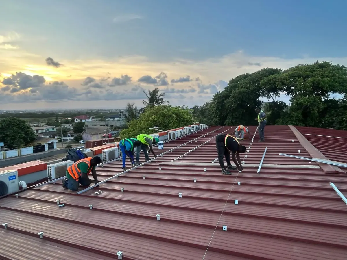 Site photo from the team behind solar system Ghana projects: Mounting rails fixed on a metal roof before the modules go down