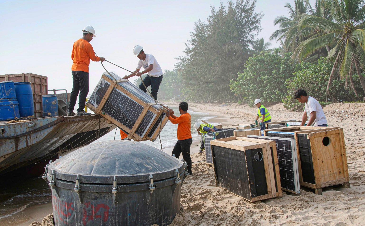 Solar panels and battery equipment landed by barge for an off-grid solar Philippines project on a beach