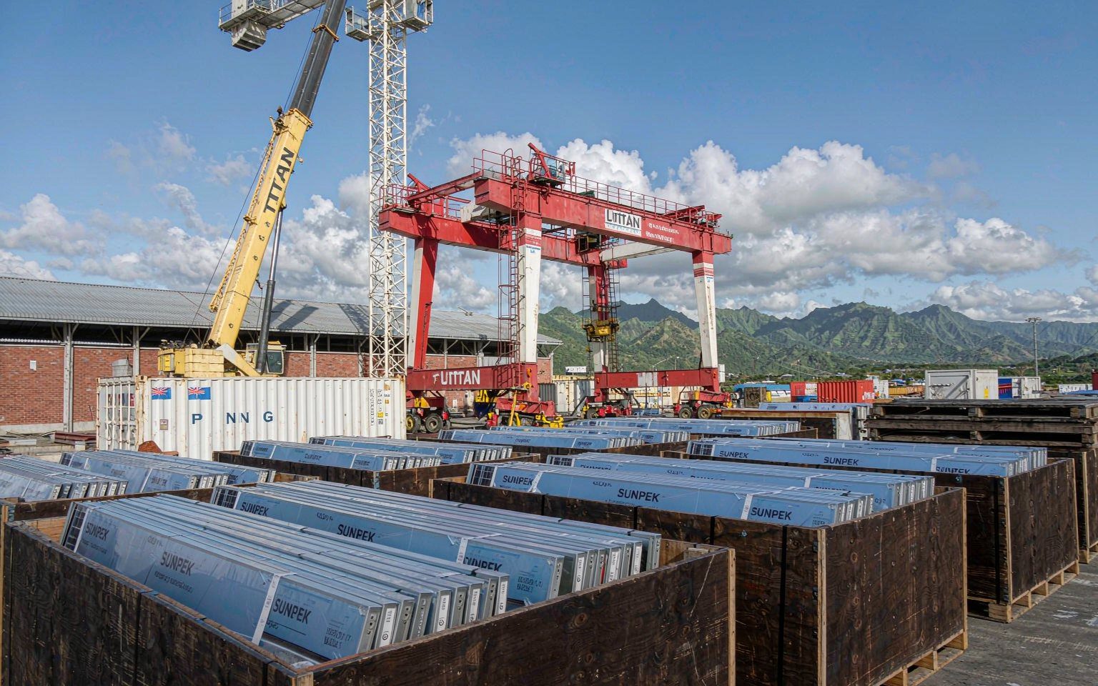 Papua New Guinea solar import shipment: containers of solar modules unloaded at a Port Moresby port terminal