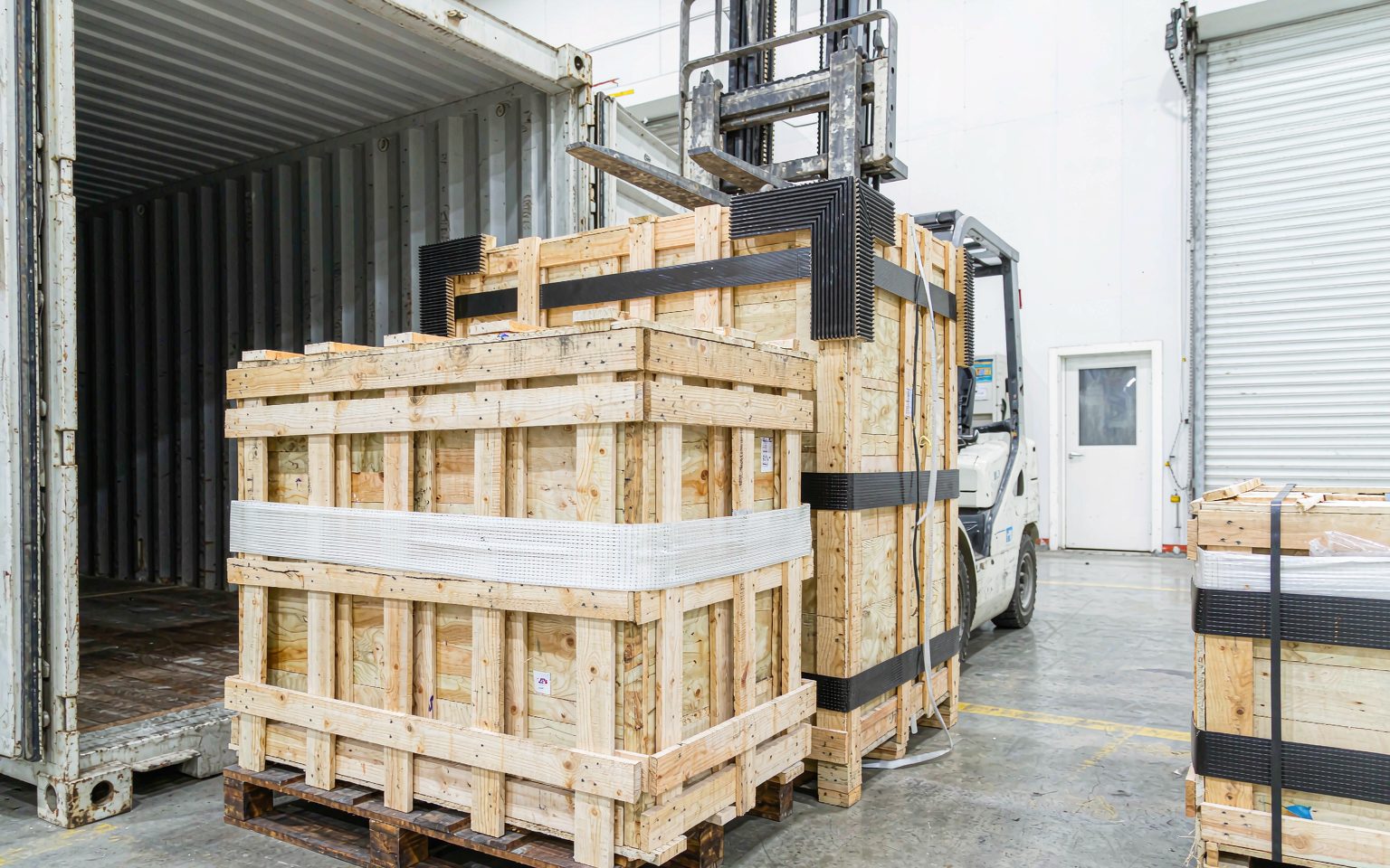 Palletised modules in a shipping container, the import leg of the solar panel price Philippines landed cost