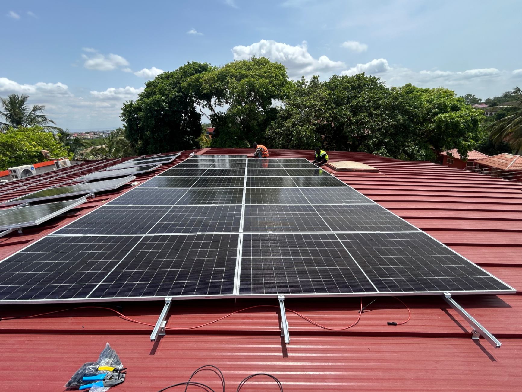Mars Solar technicians installing solar modules on a red pitched roof during commissioning