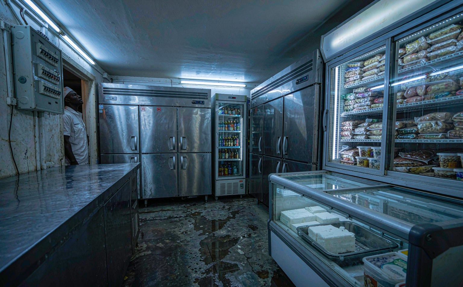 Hotel kitchen and cold room under emergency lighting during an outage, part of power outage cost for hotels in Nigeria