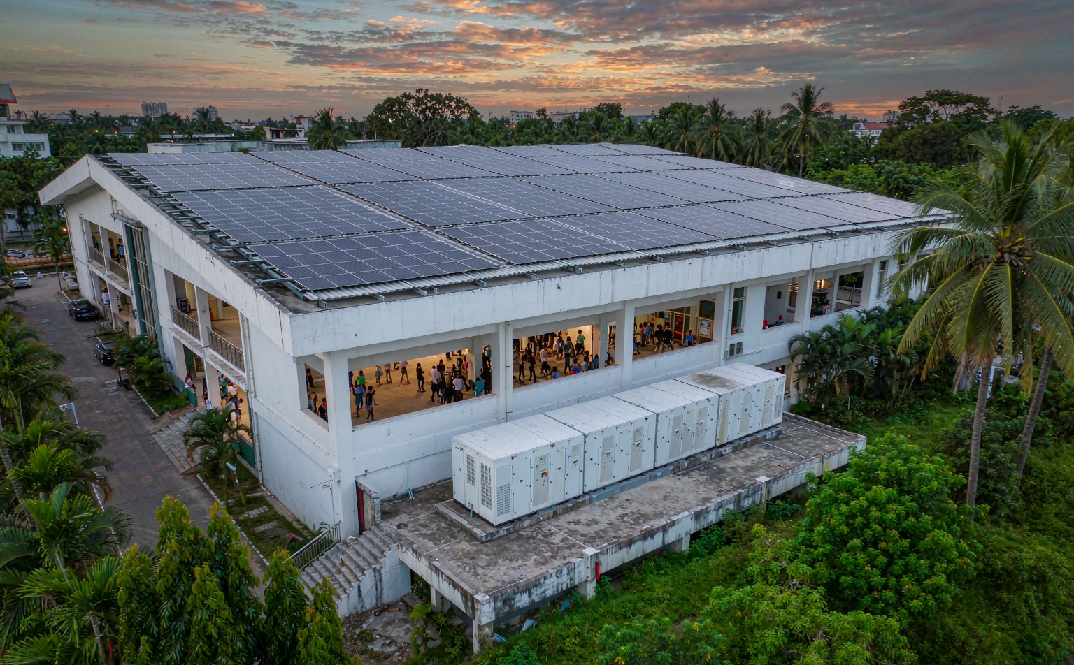 Rooftop solar array and battery cabinets on a Nigerian hotel, showing how power outage cost for hotels in Nigeria is cut