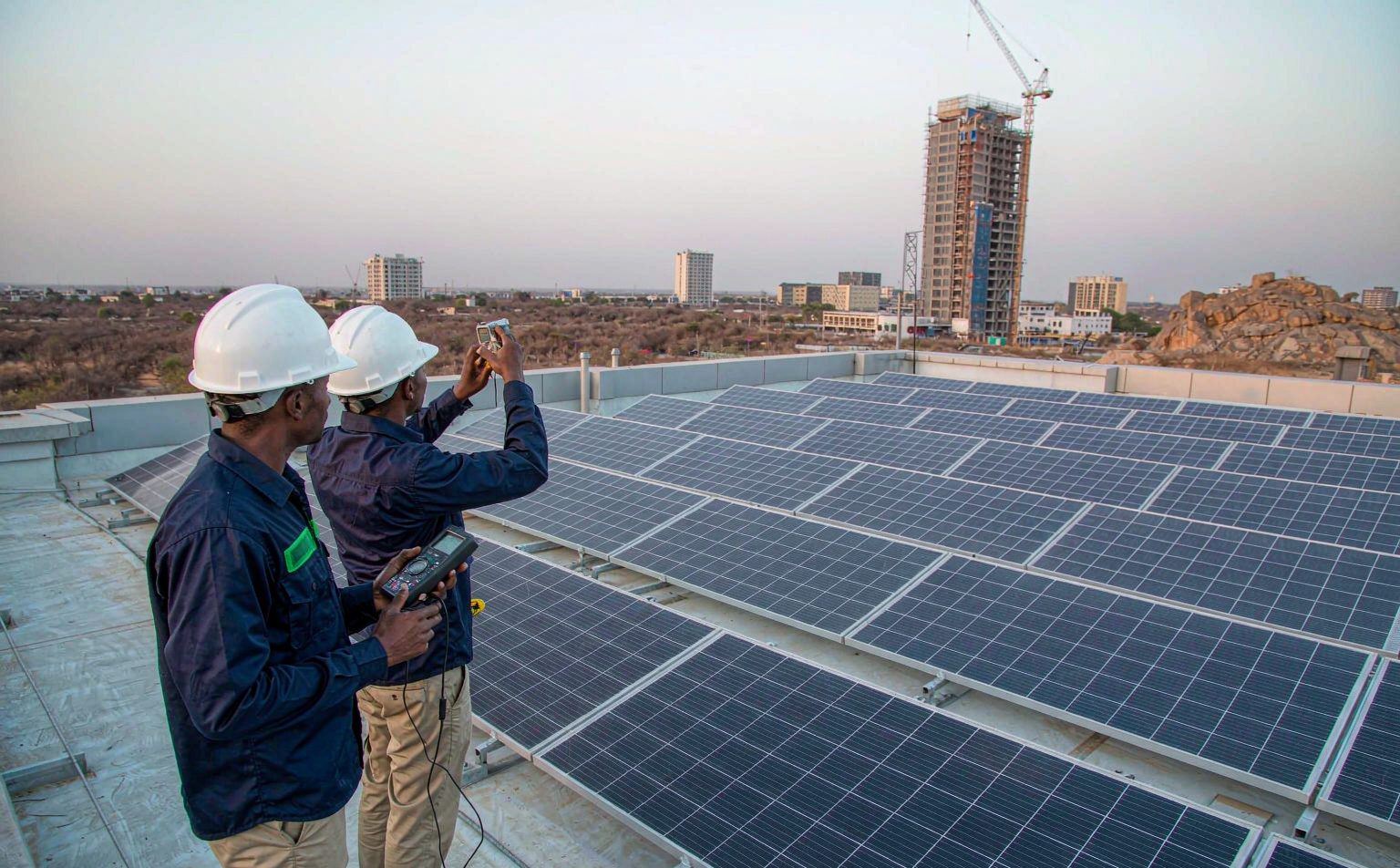 solar company in Abuja engineers surveying a commercial rooftop array