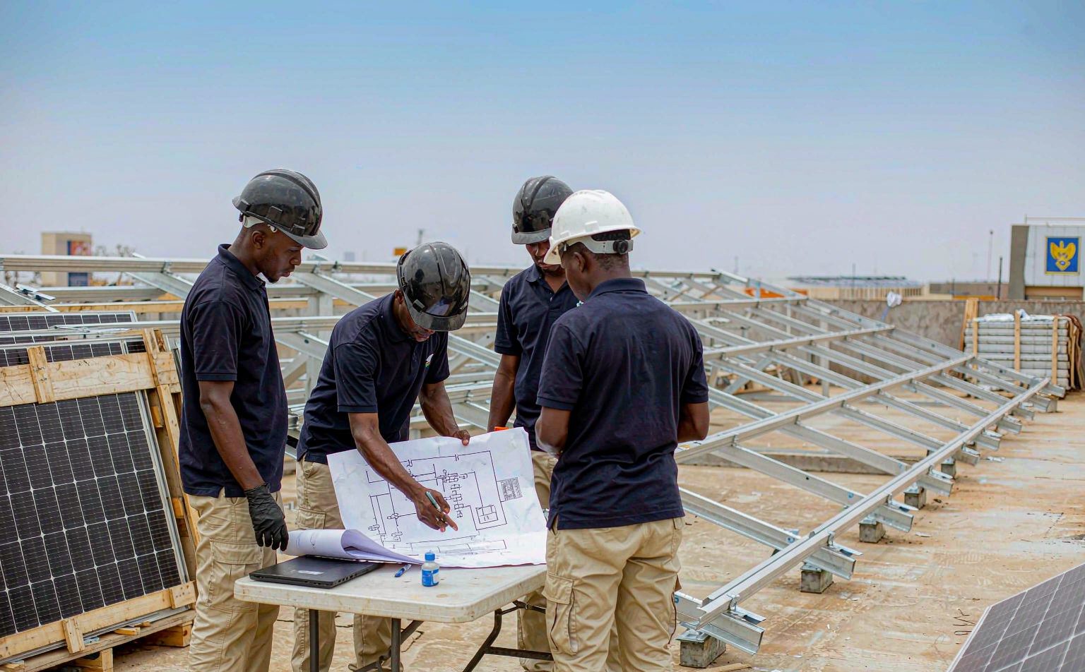 solar company in Abuja team reviewing a single-line diagram on site
