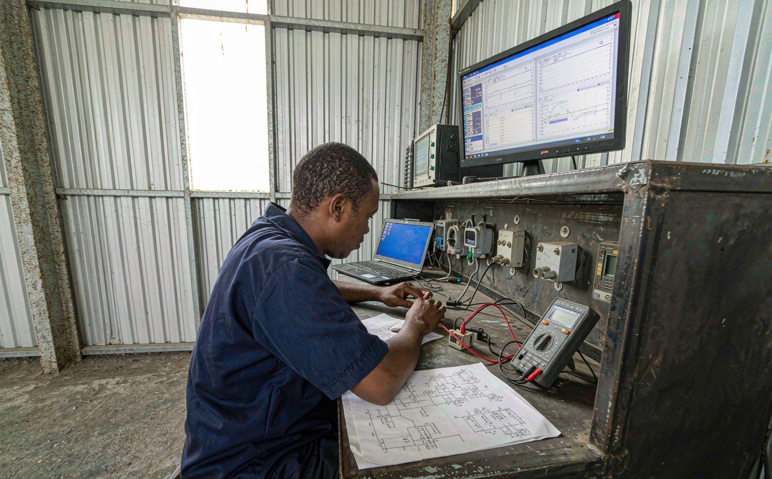 engineer reviewing a single-line diagram for a Central America solar project